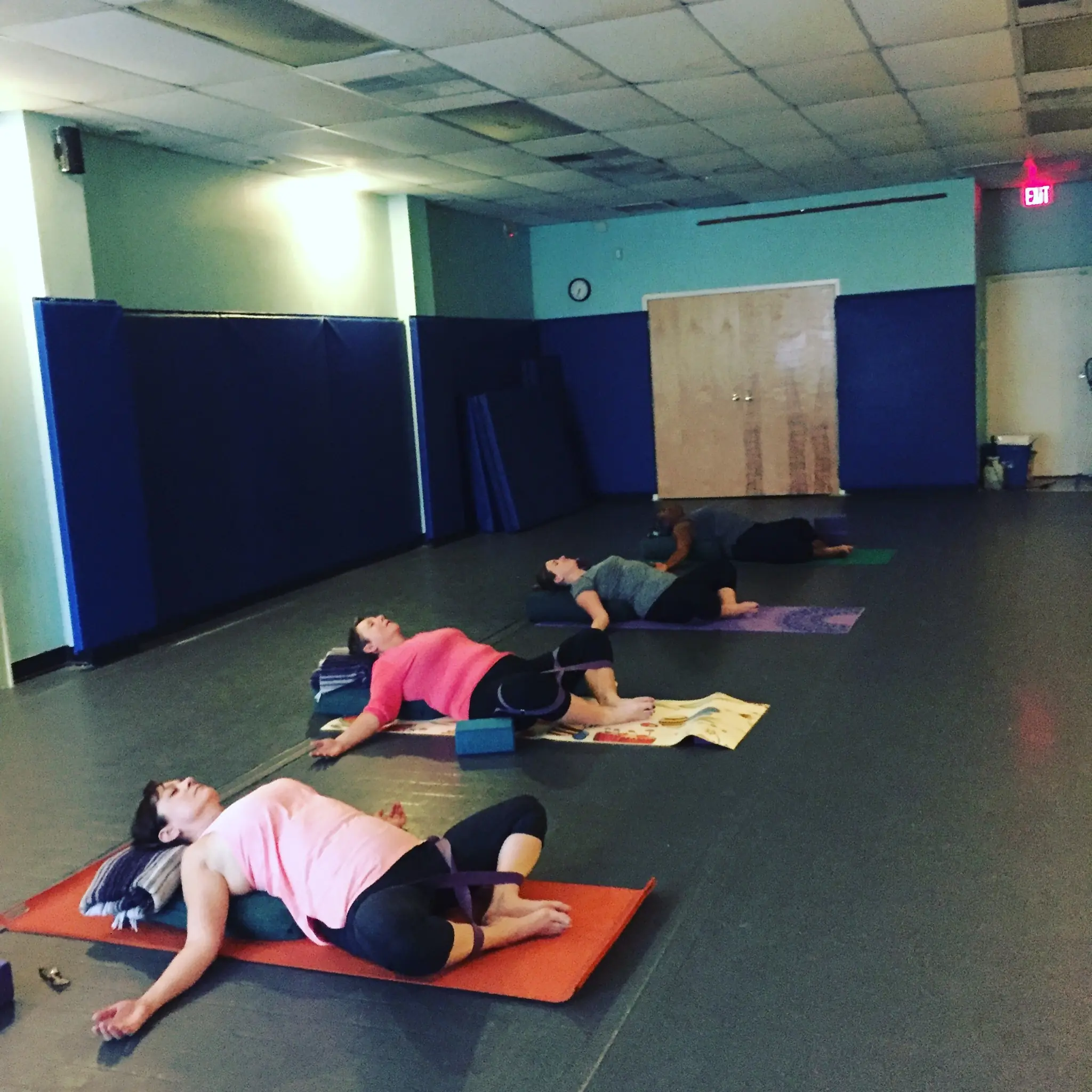 Students settled into a supported reclining pose during a mindfulness class