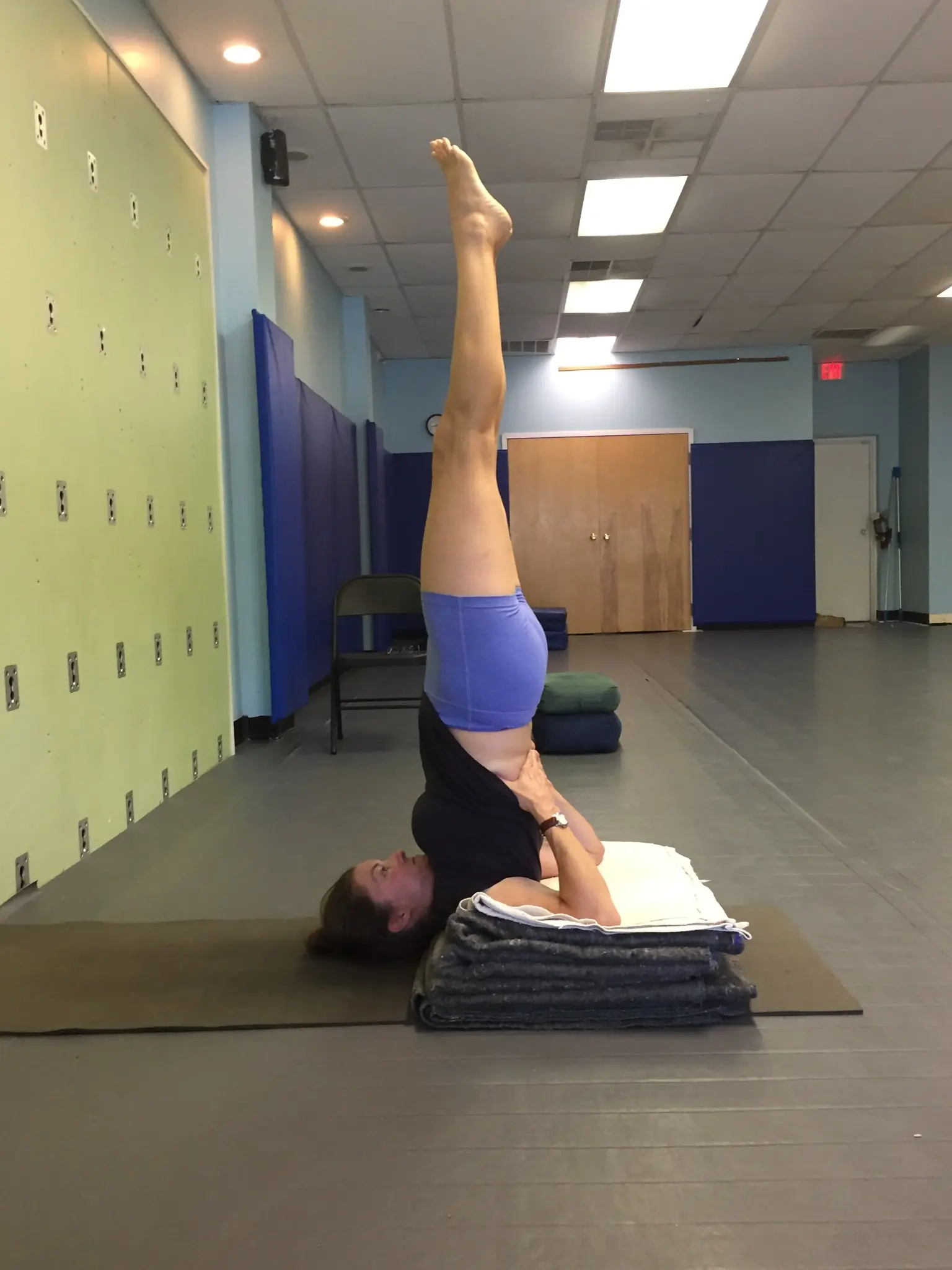 A student in a blanket-supported shoulderstand